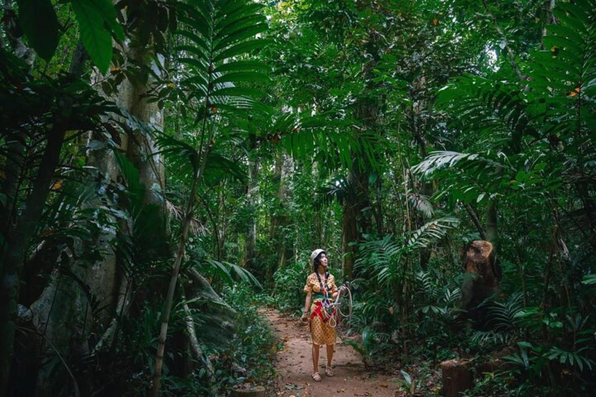 a woman walking down a trail in the jungle