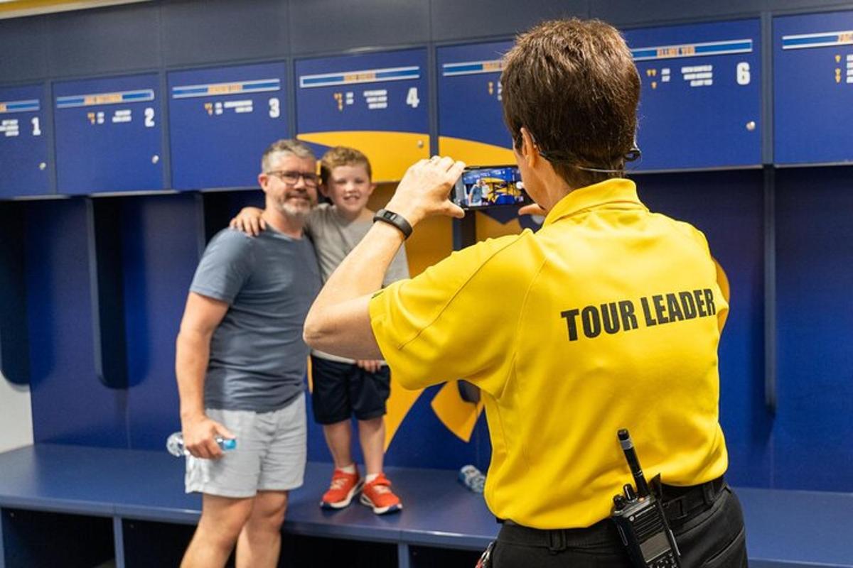 a man taking a picture of two men in a locker room