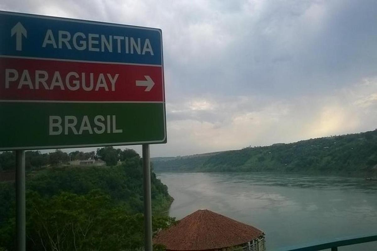 a street sign in front of a river