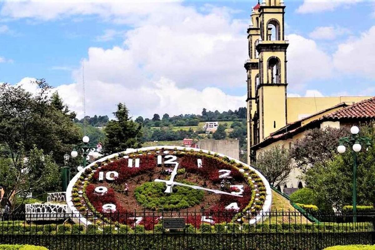 a large clock in front of a building with a tower