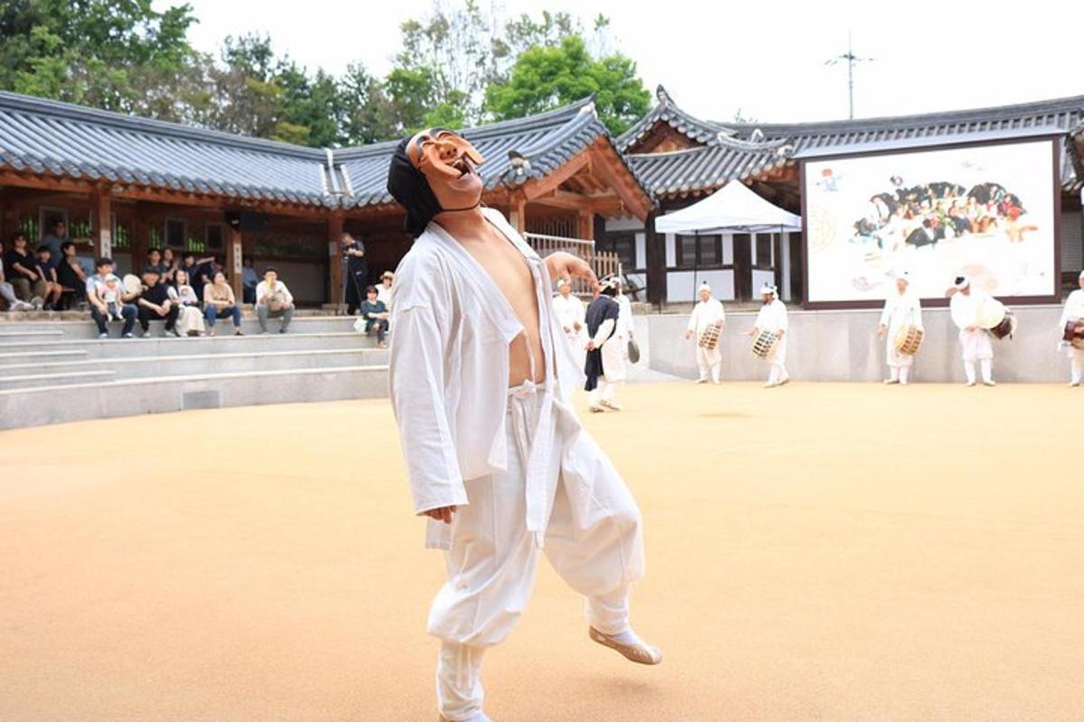 a woman in white kimonos dancing in front of a building
