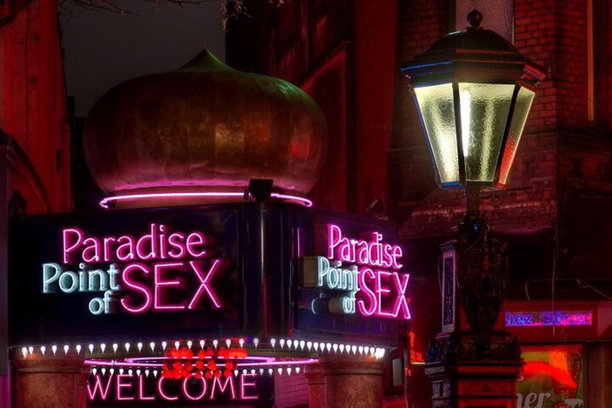 a group of neon signs on the side of a building