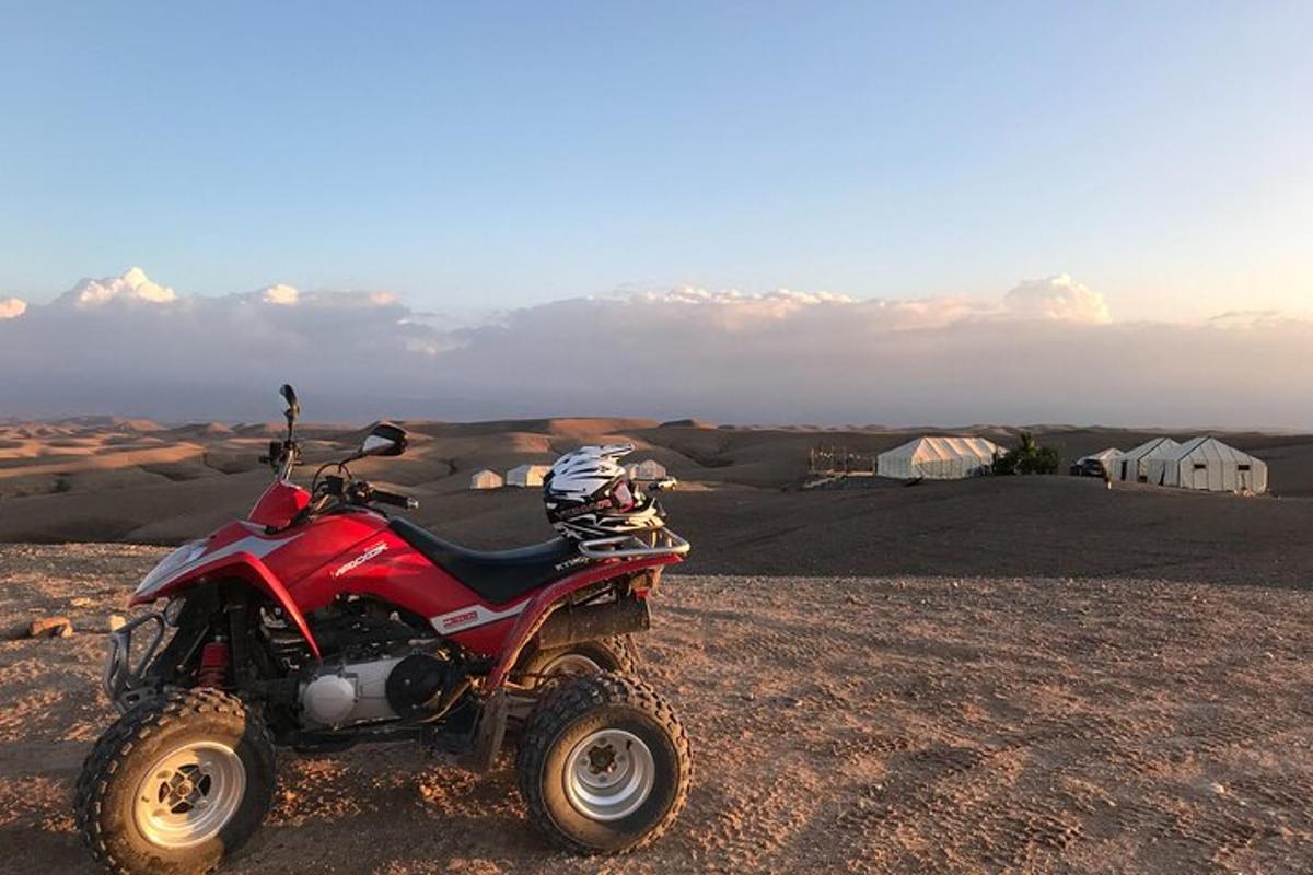 a red atv parked in the middle of a desert