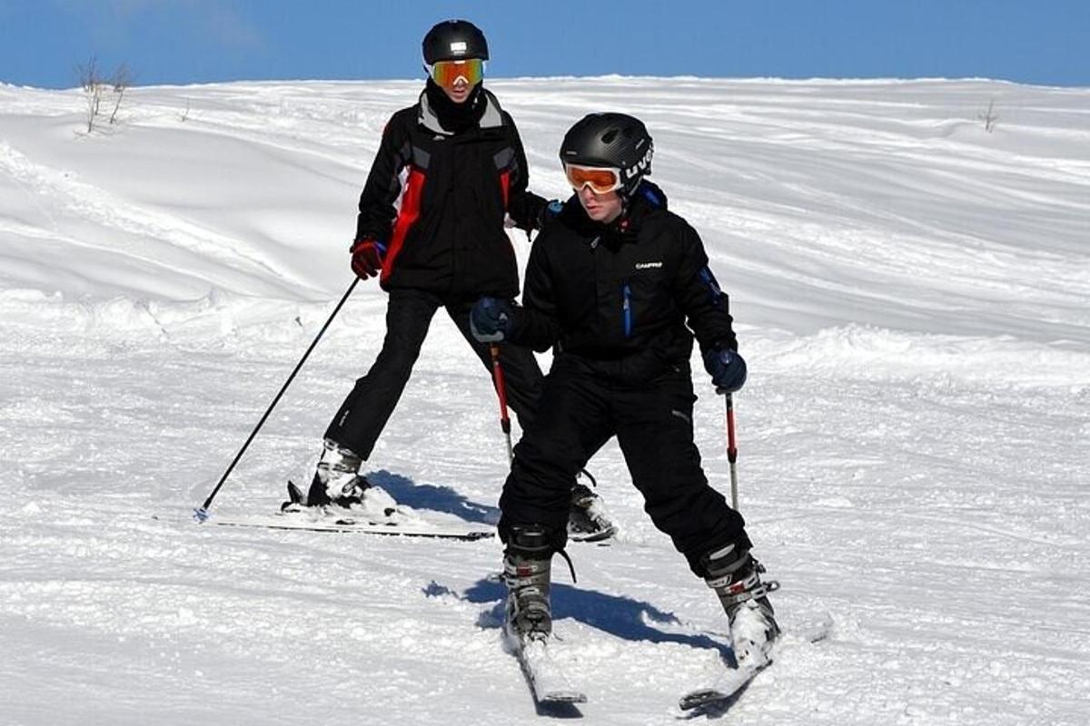 two people standing on skis in the snow