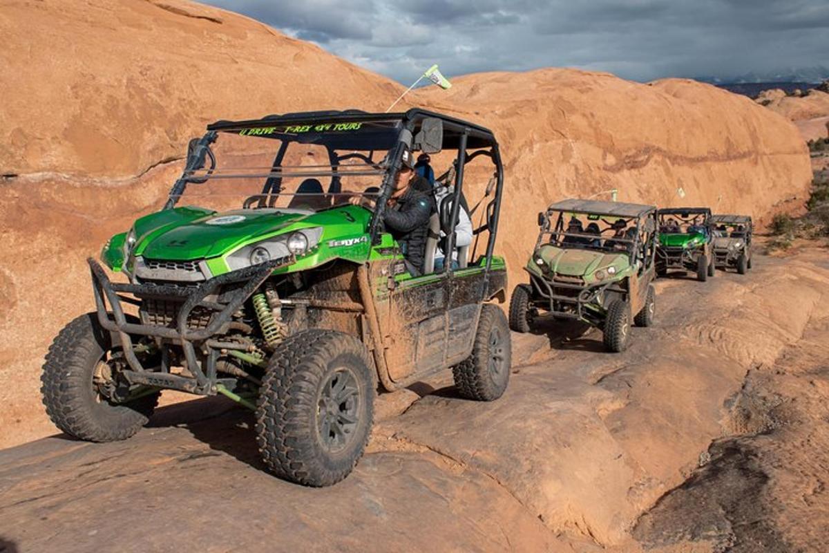a group of atvs and jeeps on a dirt road