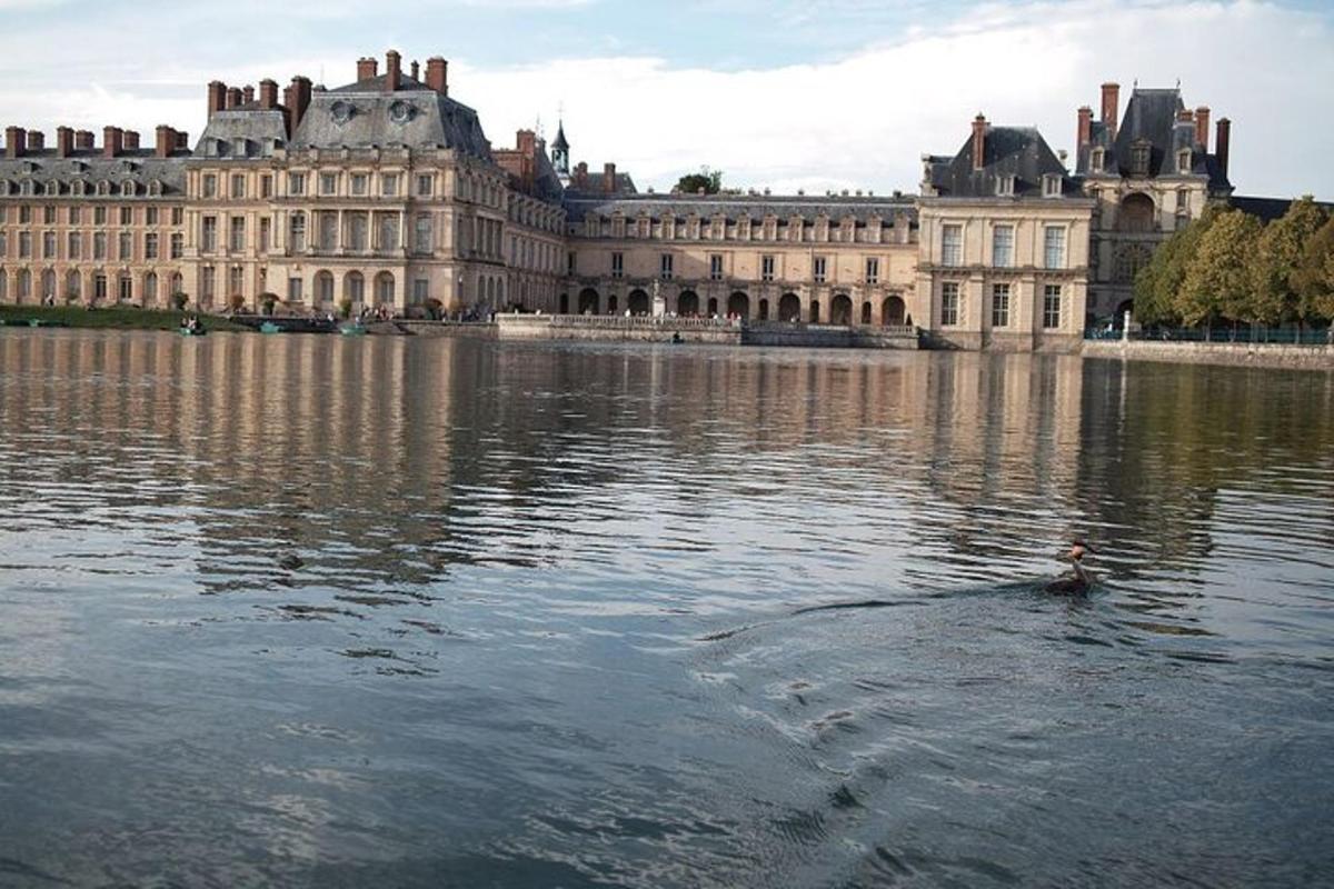 a person in the water in front of a large building
