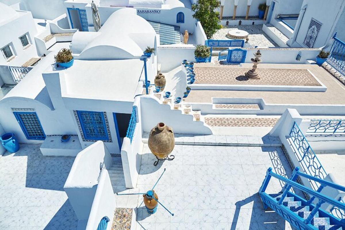 an aerial view of a white building with blue accents