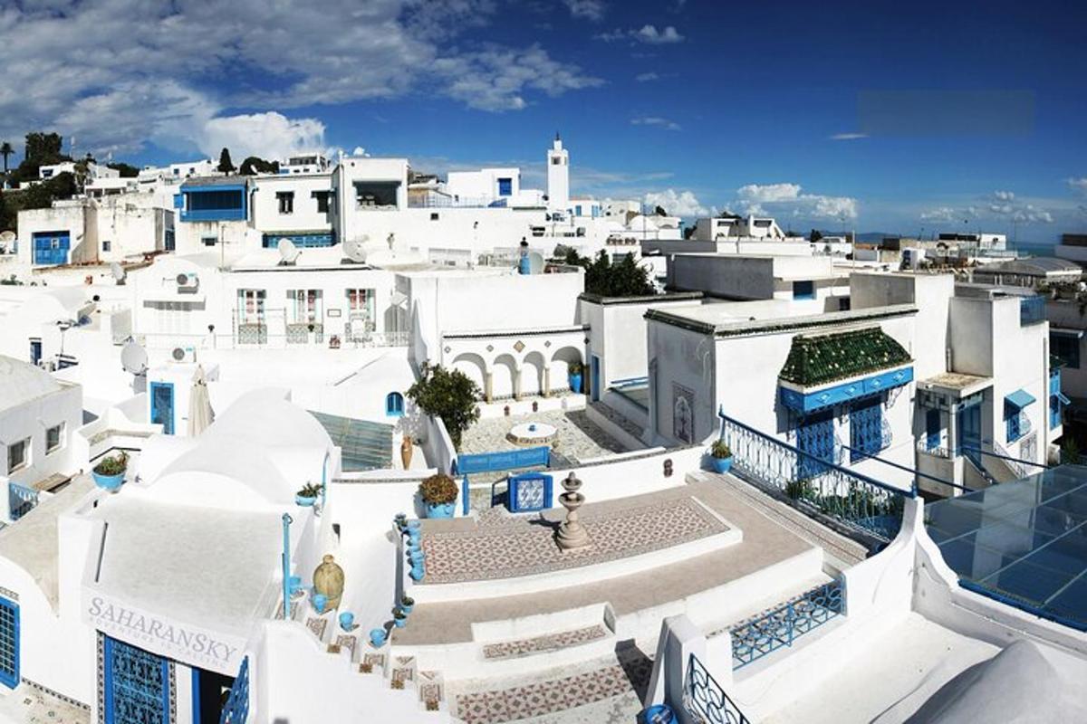 an aerial view of a city with white buildings