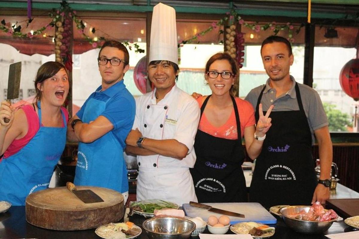 a group of people standing in a kitchen