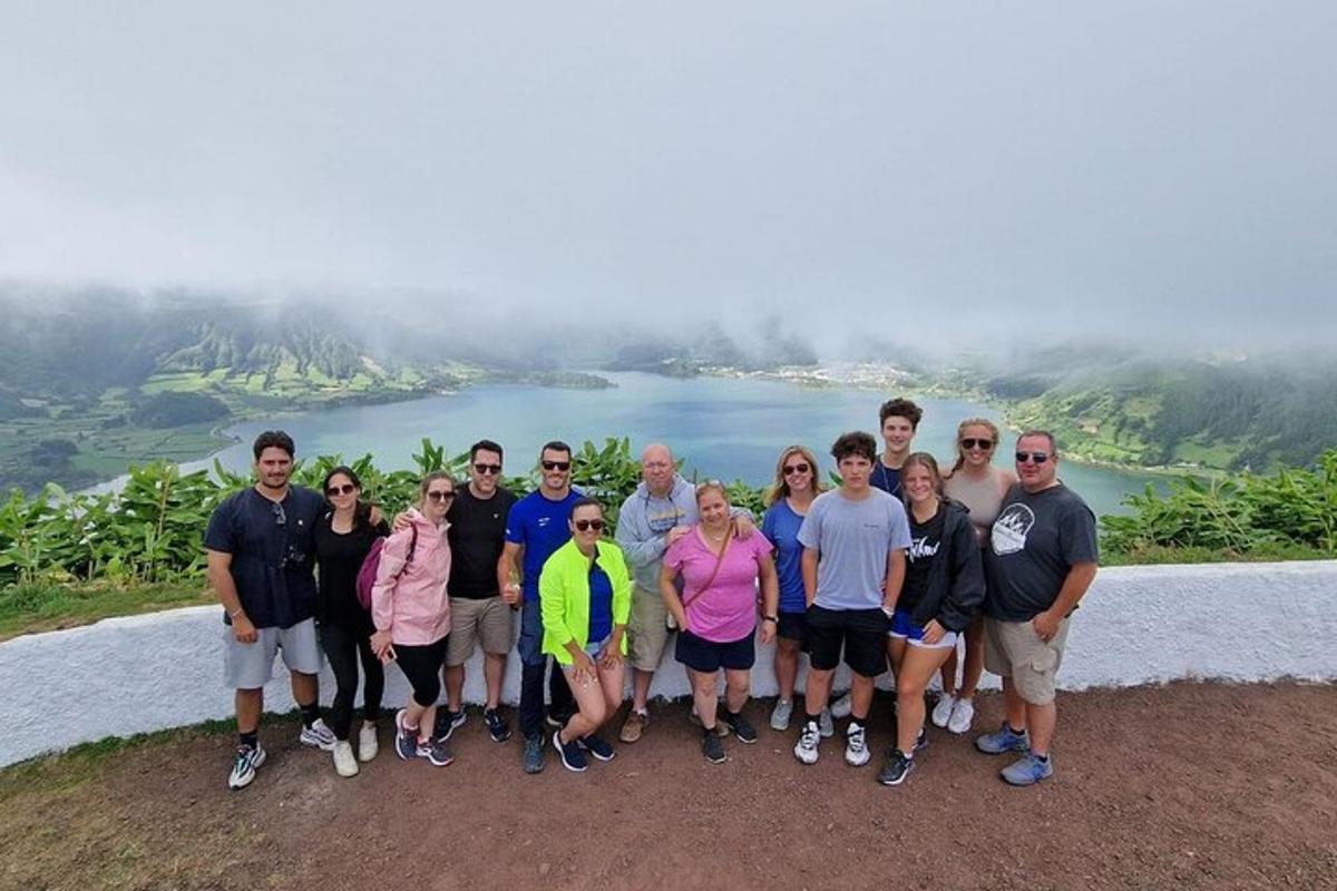 a group of people posing for a picture on a mountain