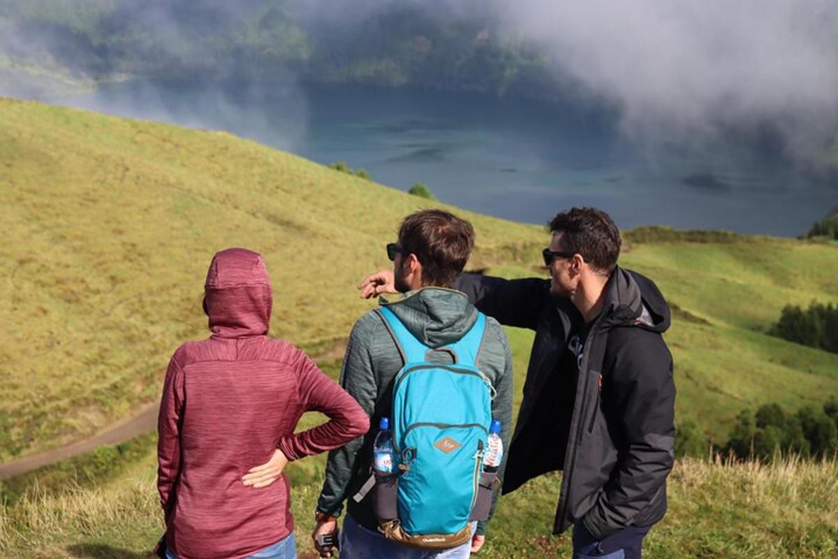 a group of three people walking on a hill