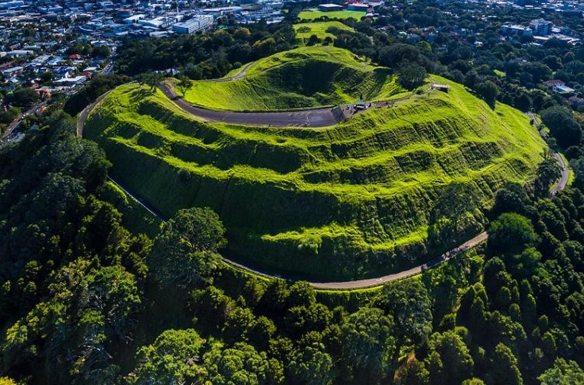 a grassy hill with a winding road on it
