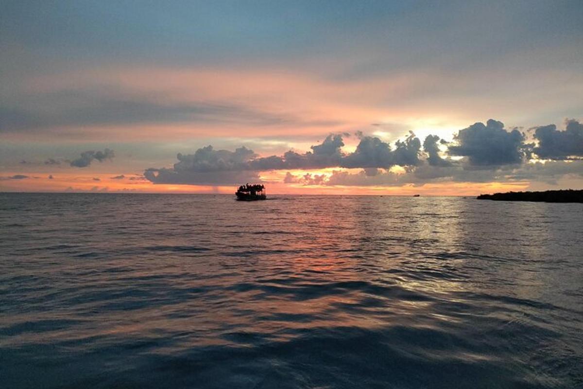 una barca sull'acqua con un tramonto