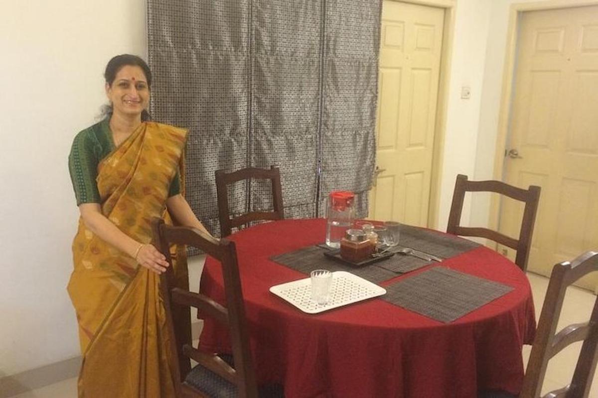a woman standing next to a table with a red table cloth