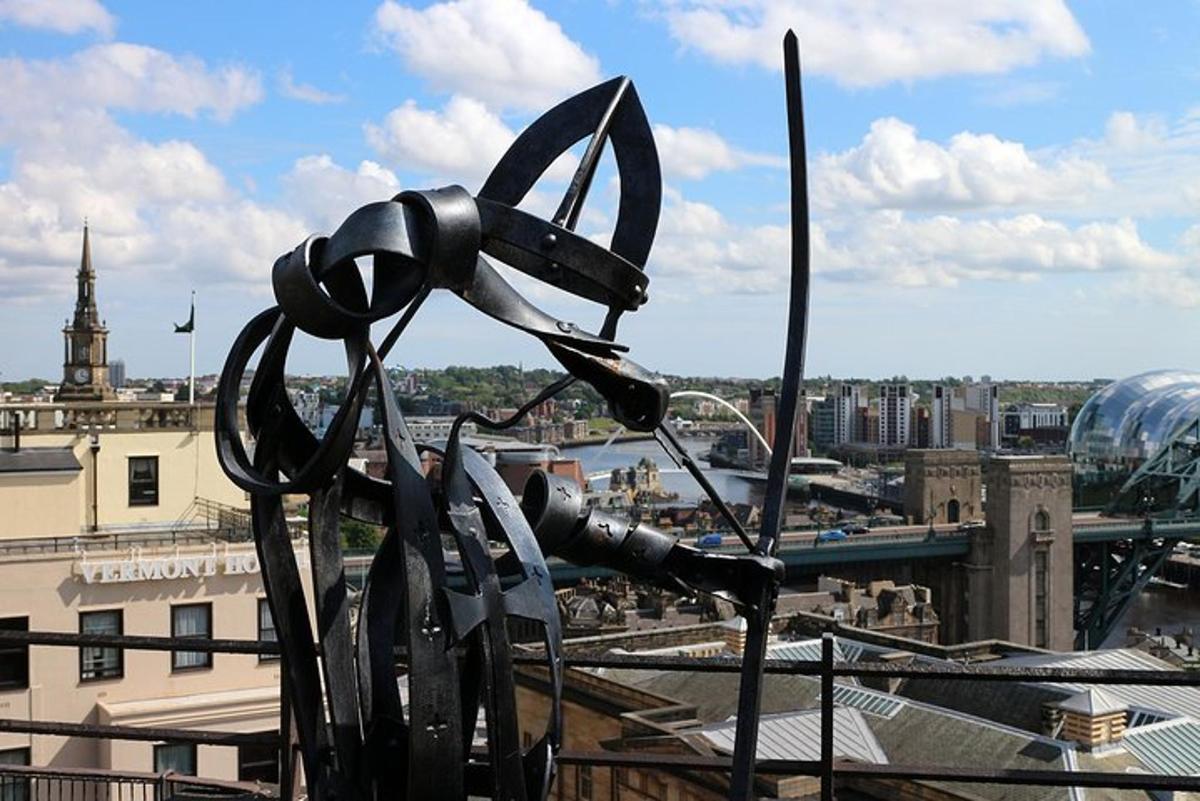 a sculpture of a pair of scissors on top of a building