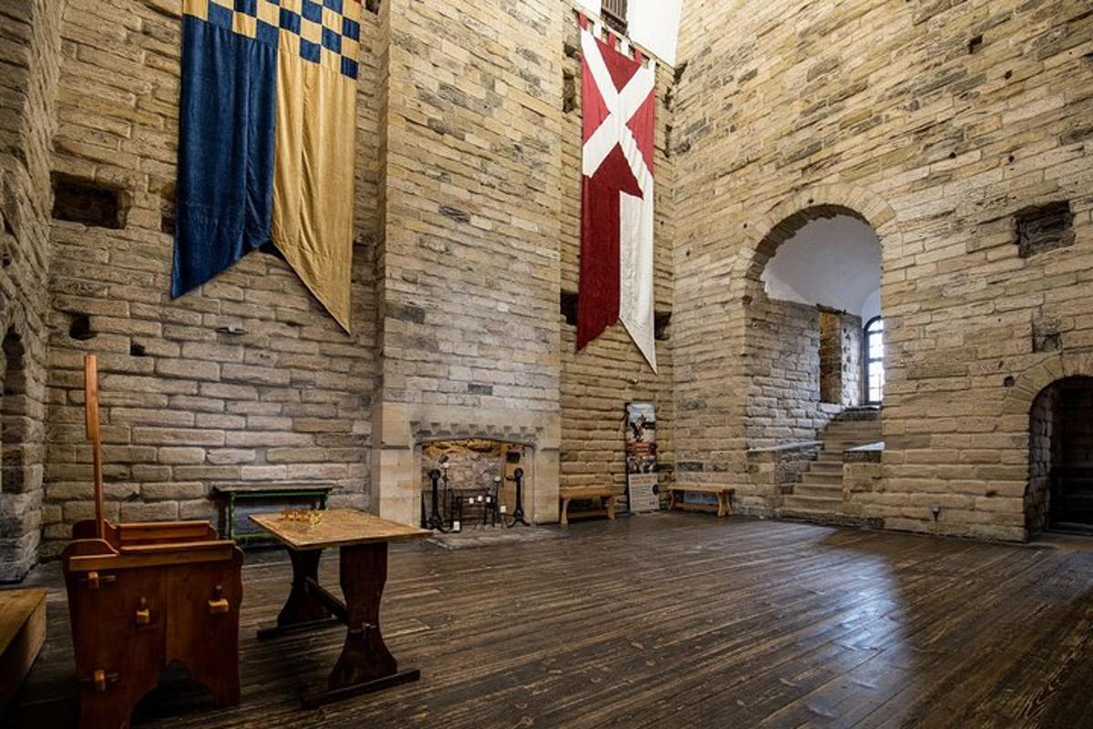 a large room with a brick wall with flags on it