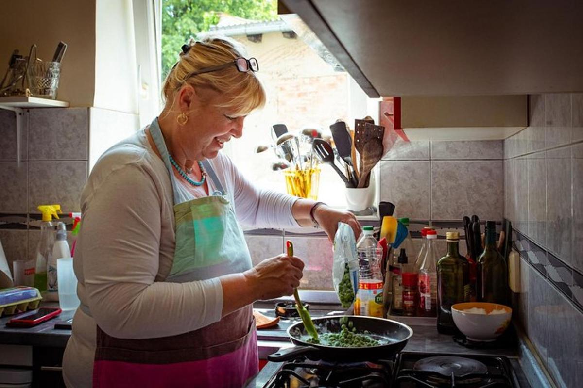 a woman standing in a kitchen preparing food
