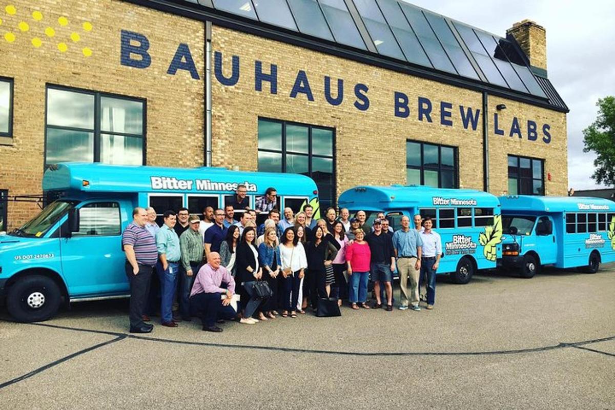 a group of people standing in front of two buses