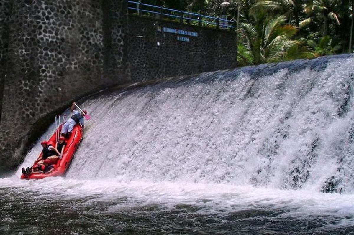 a person riding a raft on a waterfall