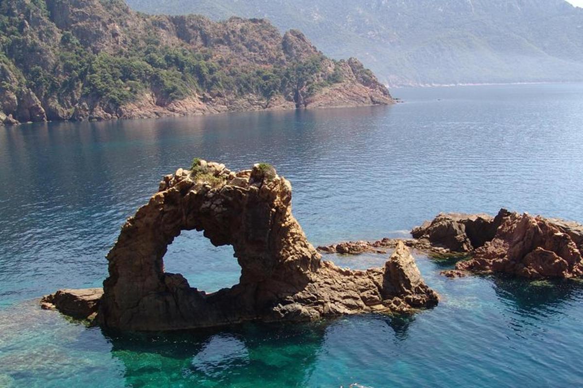 a rock formation in the middle of a body of water