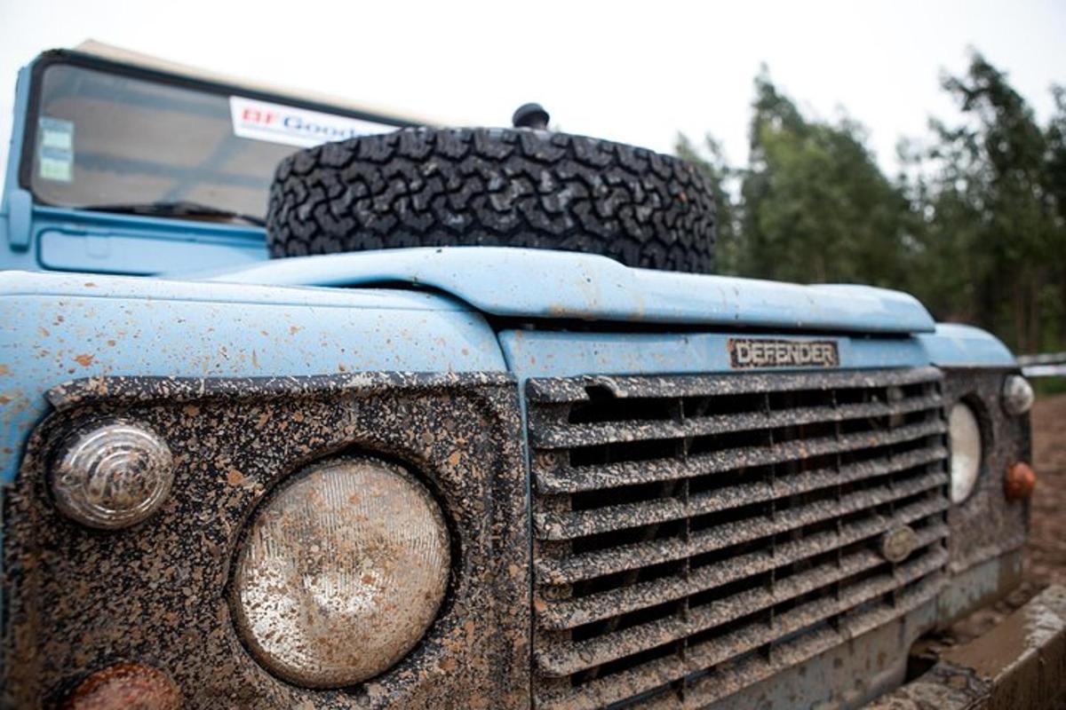 a tire sitting on the hood of an old truck