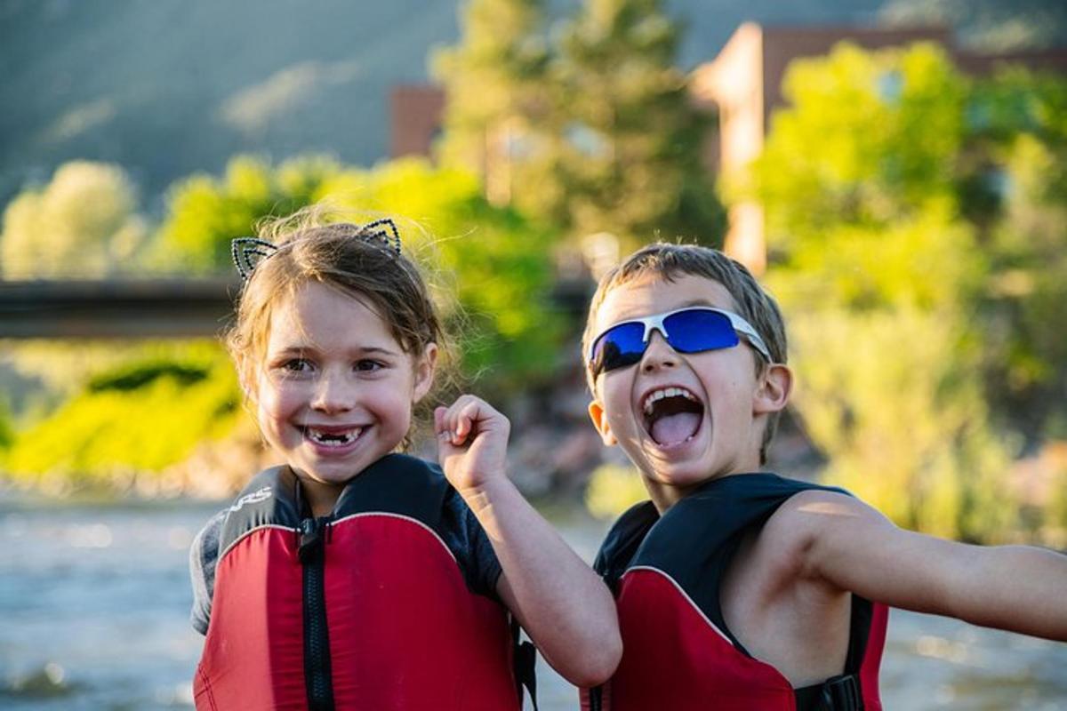 two young girls in life jackets posing for a picture