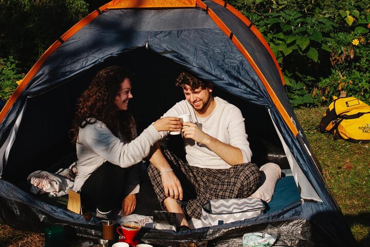 a man and a woman sitting in a tent