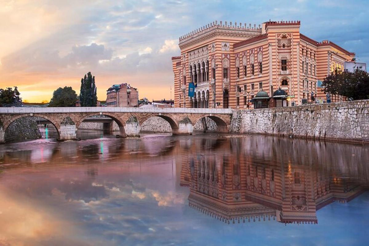 a bridge over a river in front of a building