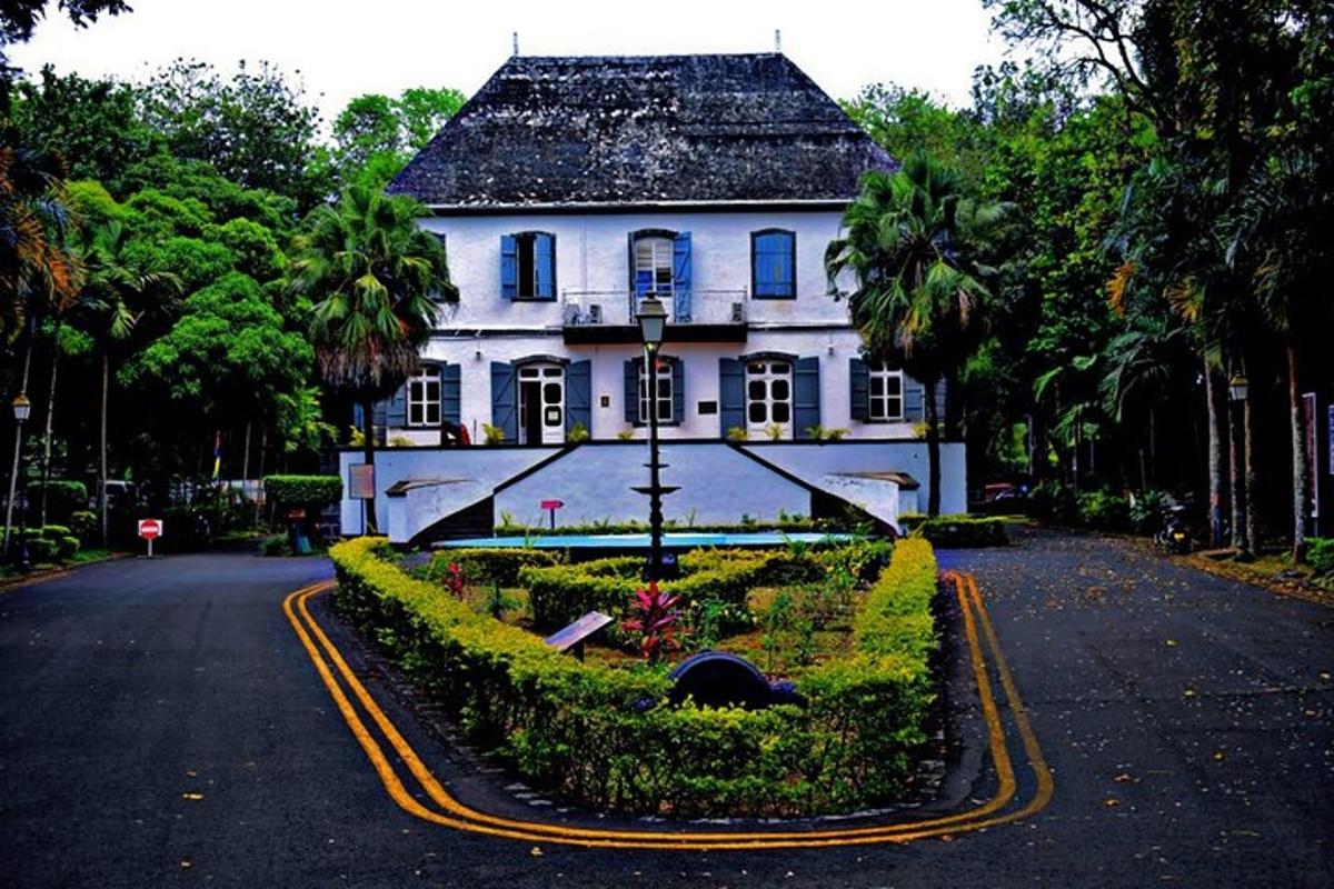 a white house with a garden in front of it