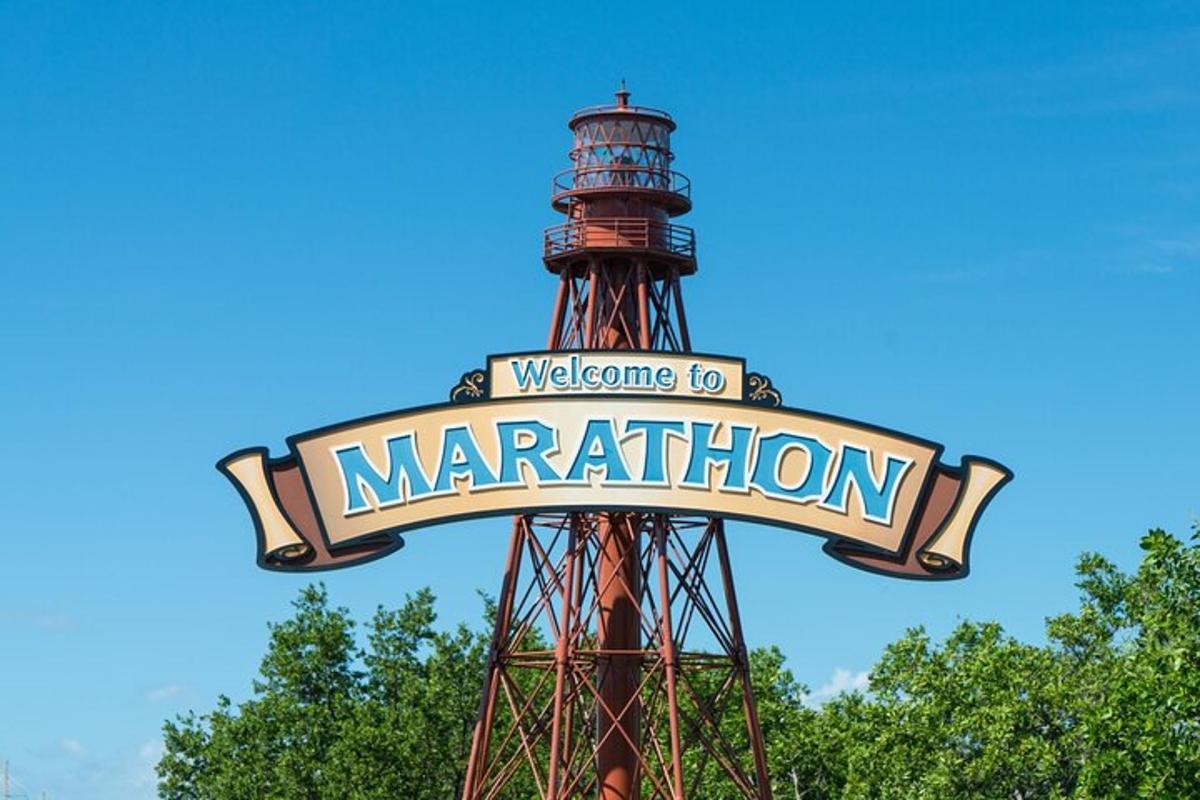 a sign in front of a water tower