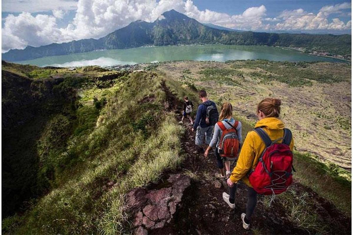 a group of people walking on a mountain trail