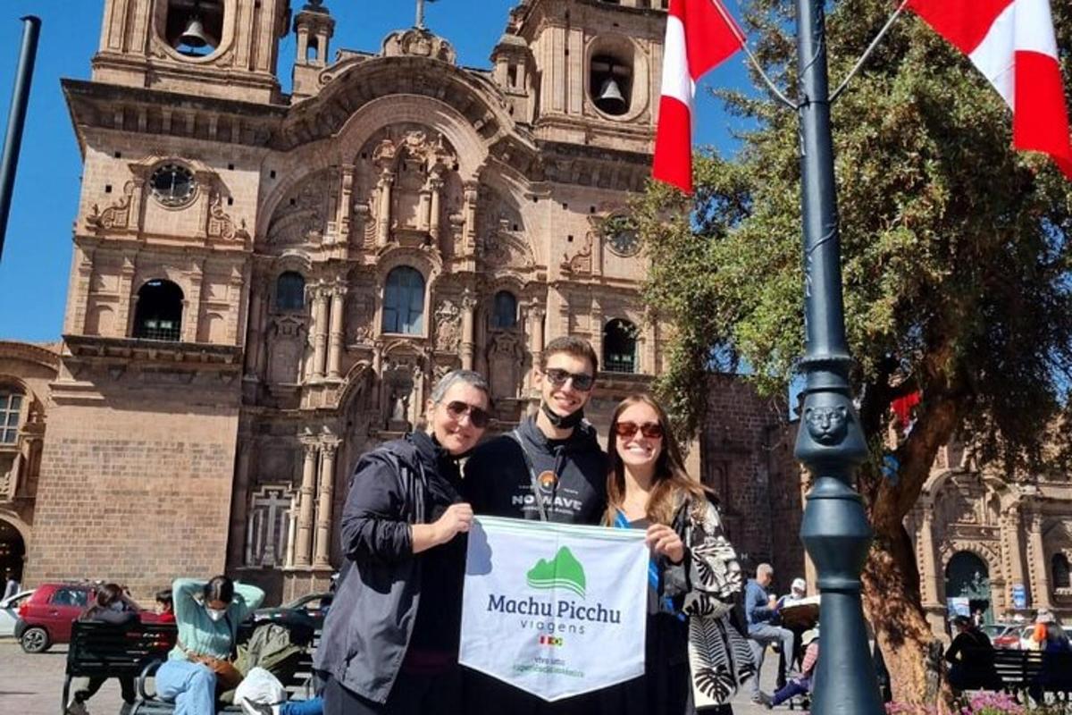 a group of people holding a sign in front of a building