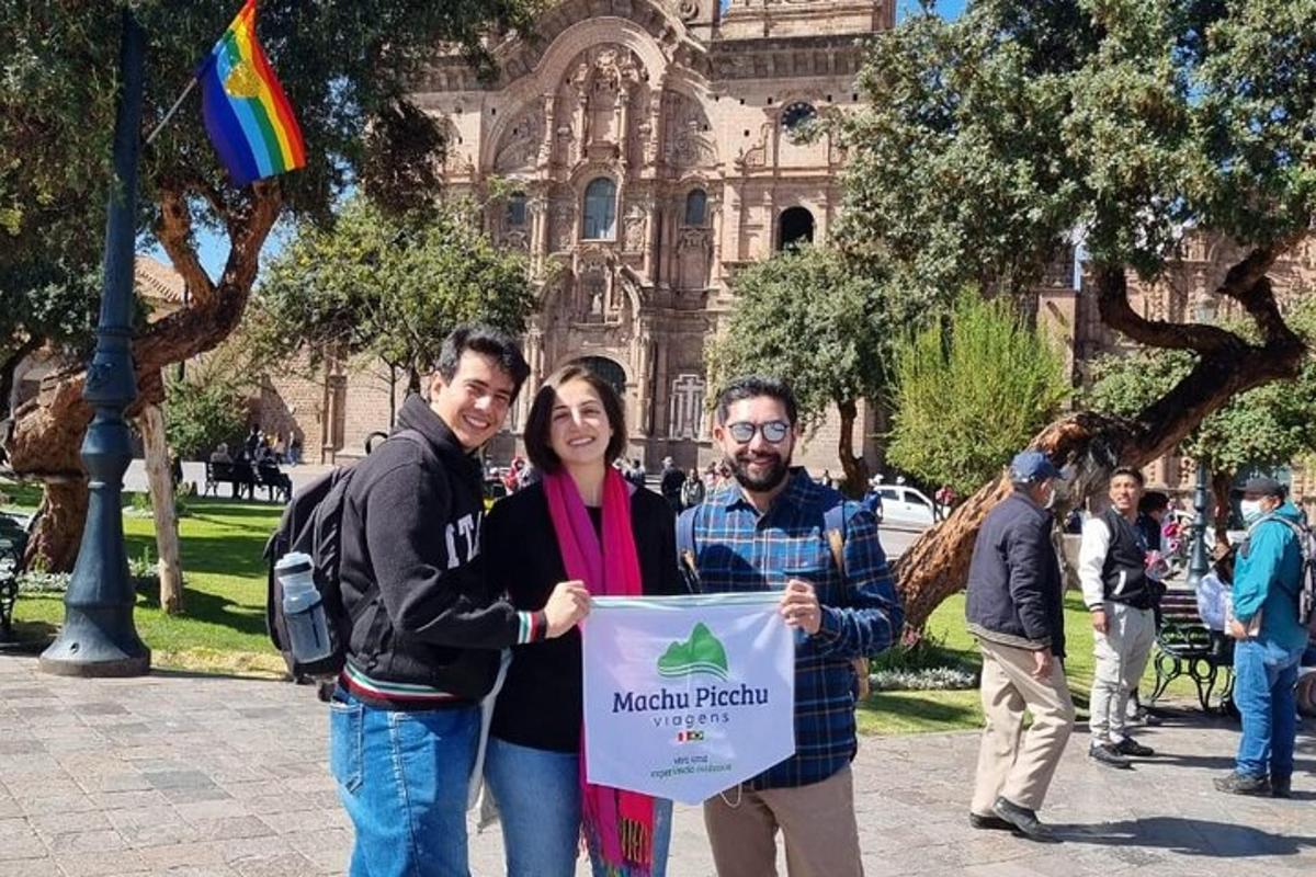 a group of people holding a sign in front of a building