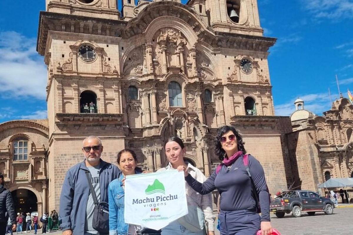 a group of people holding a sign in front of a building