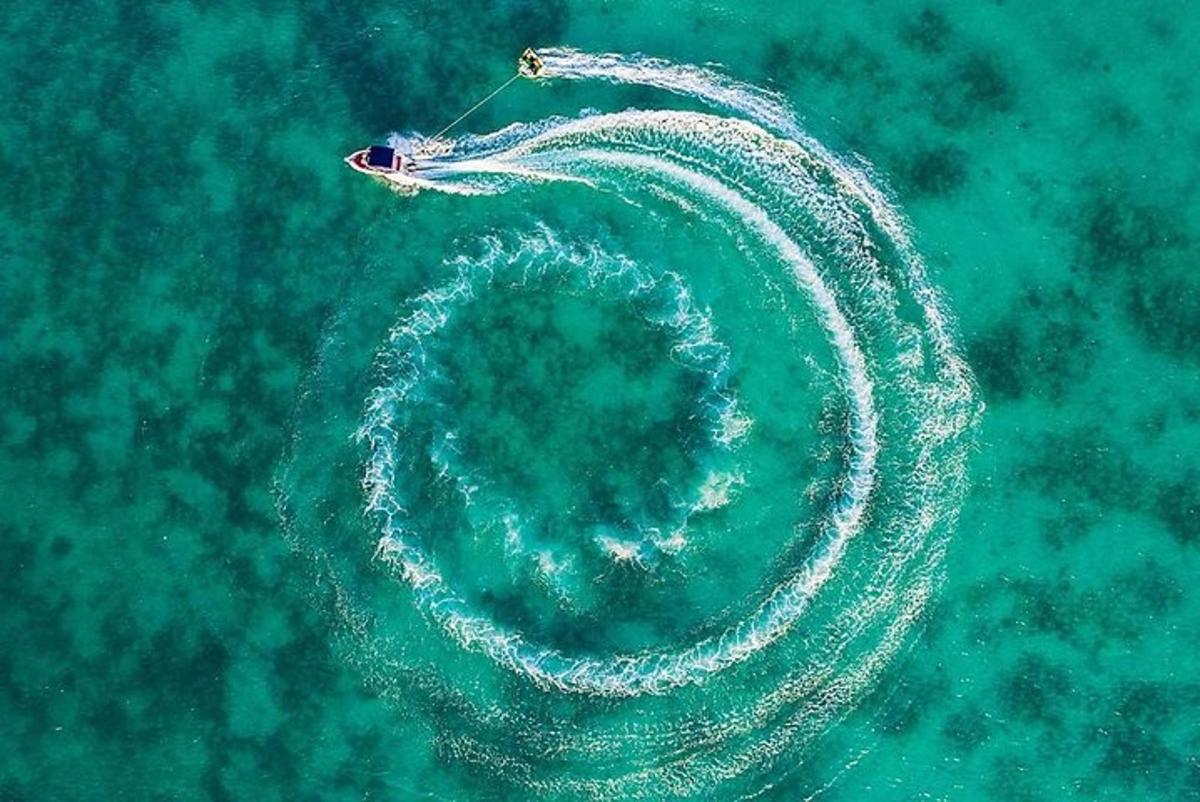 an ocean spiral in the water with a boat