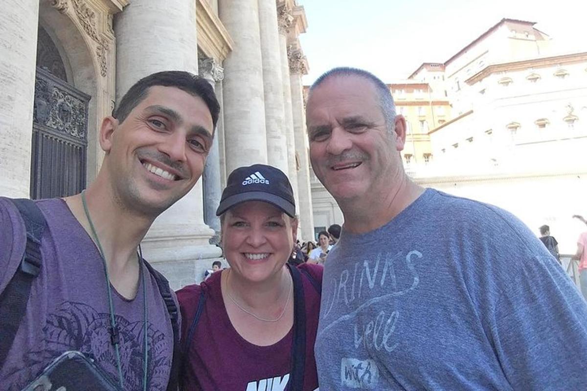 two men and a woman standing in front of a building