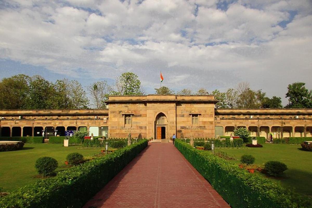 a building with a red brick walkway in a park