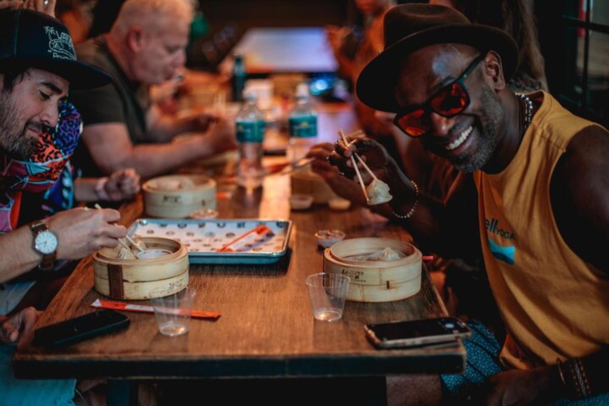 a group of men sitting at a table eating food