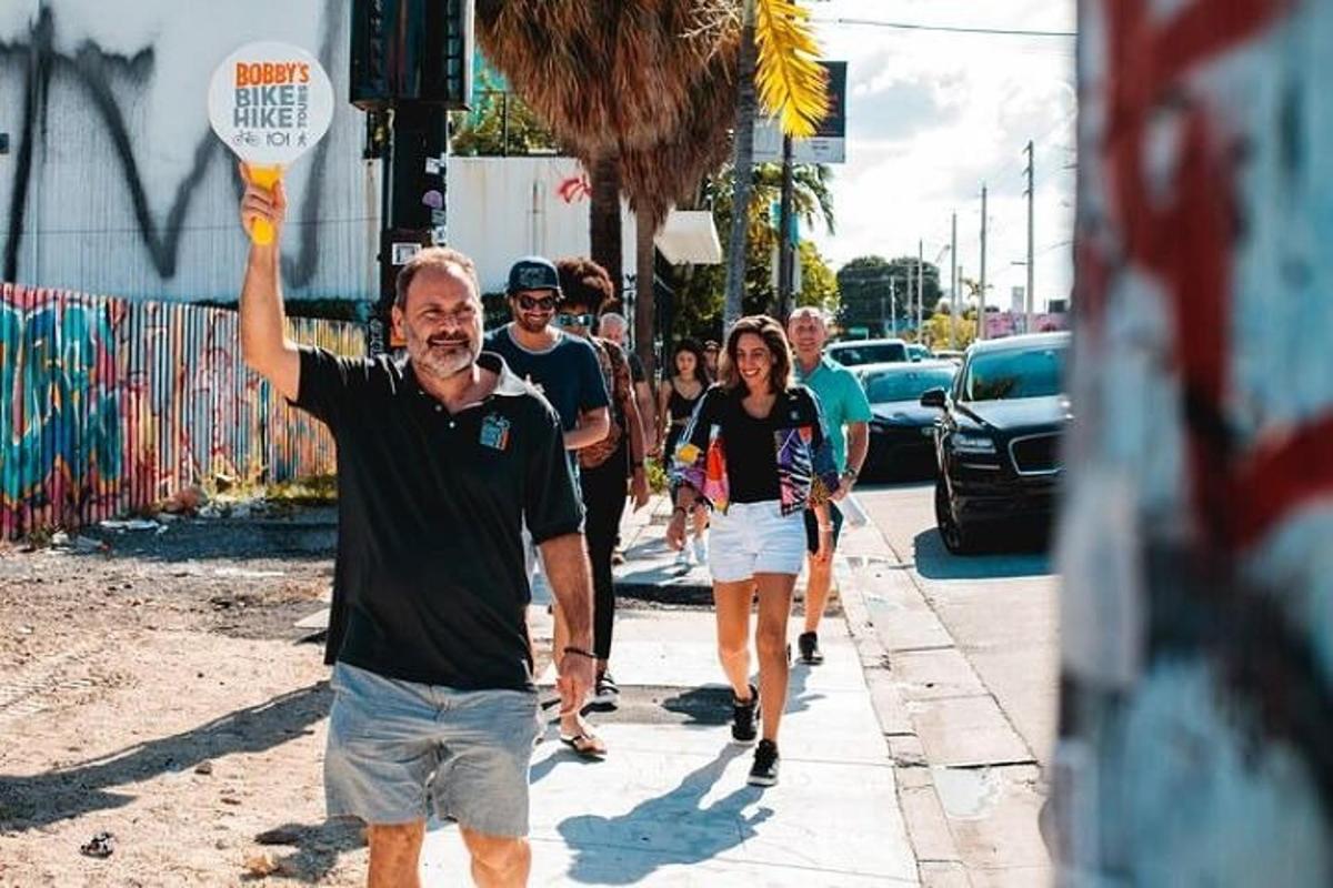 a man holding a frisbee on a city street