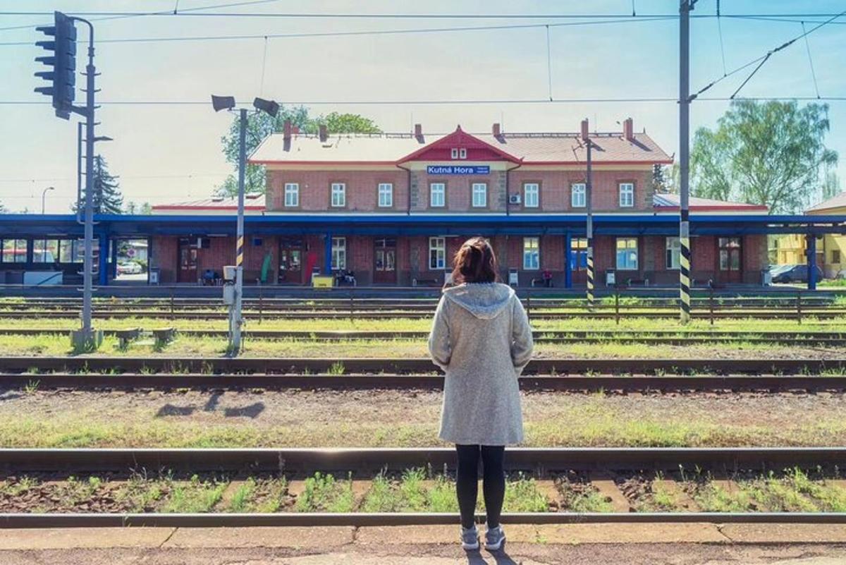 a woman standing in front of a train station