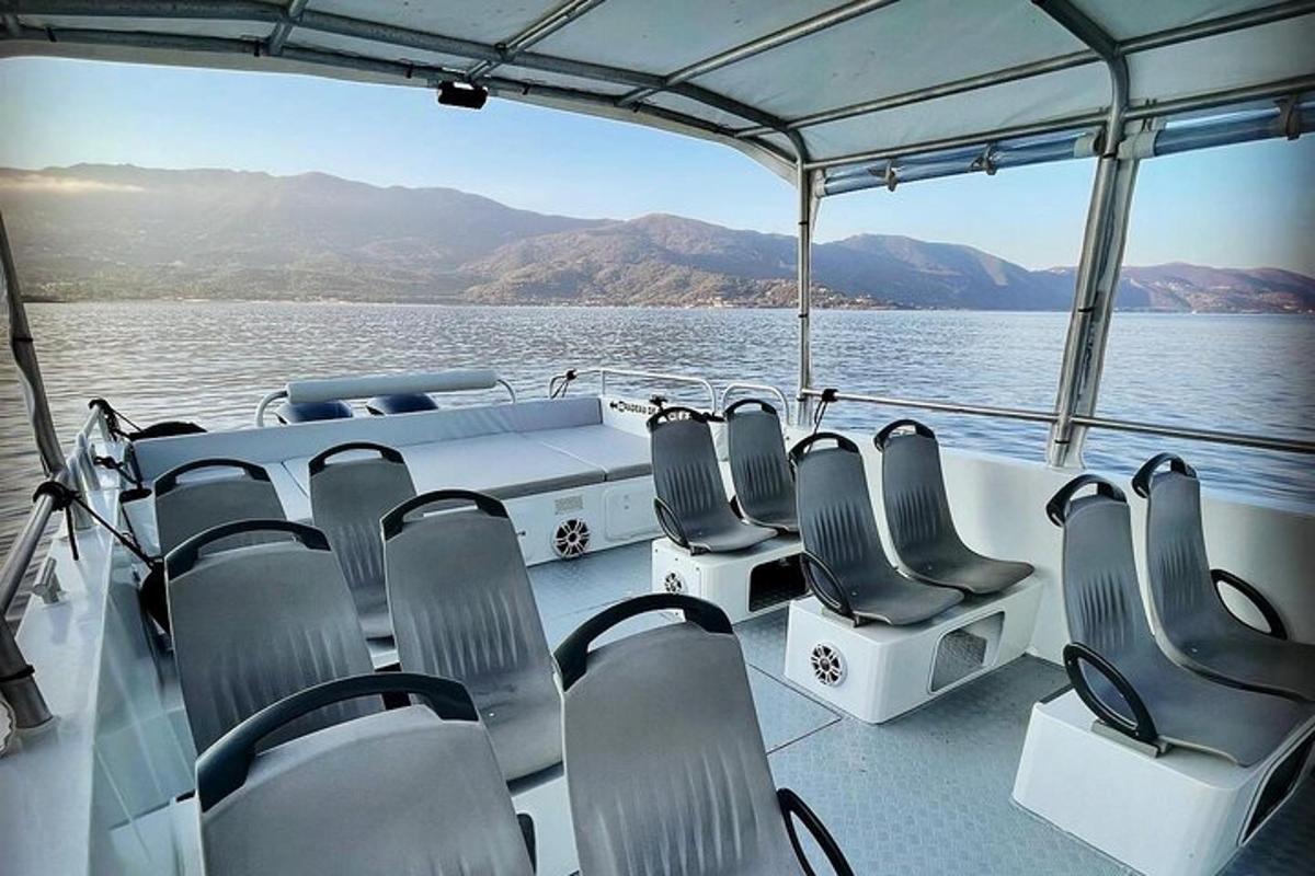 a boat with chairs and a table on the water
