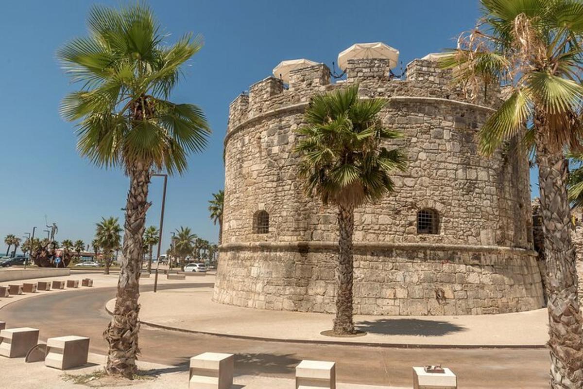a stone building with palm trees in front of it