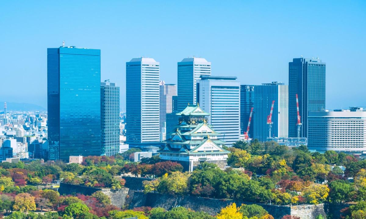 a city skyline with tall buildings and trees