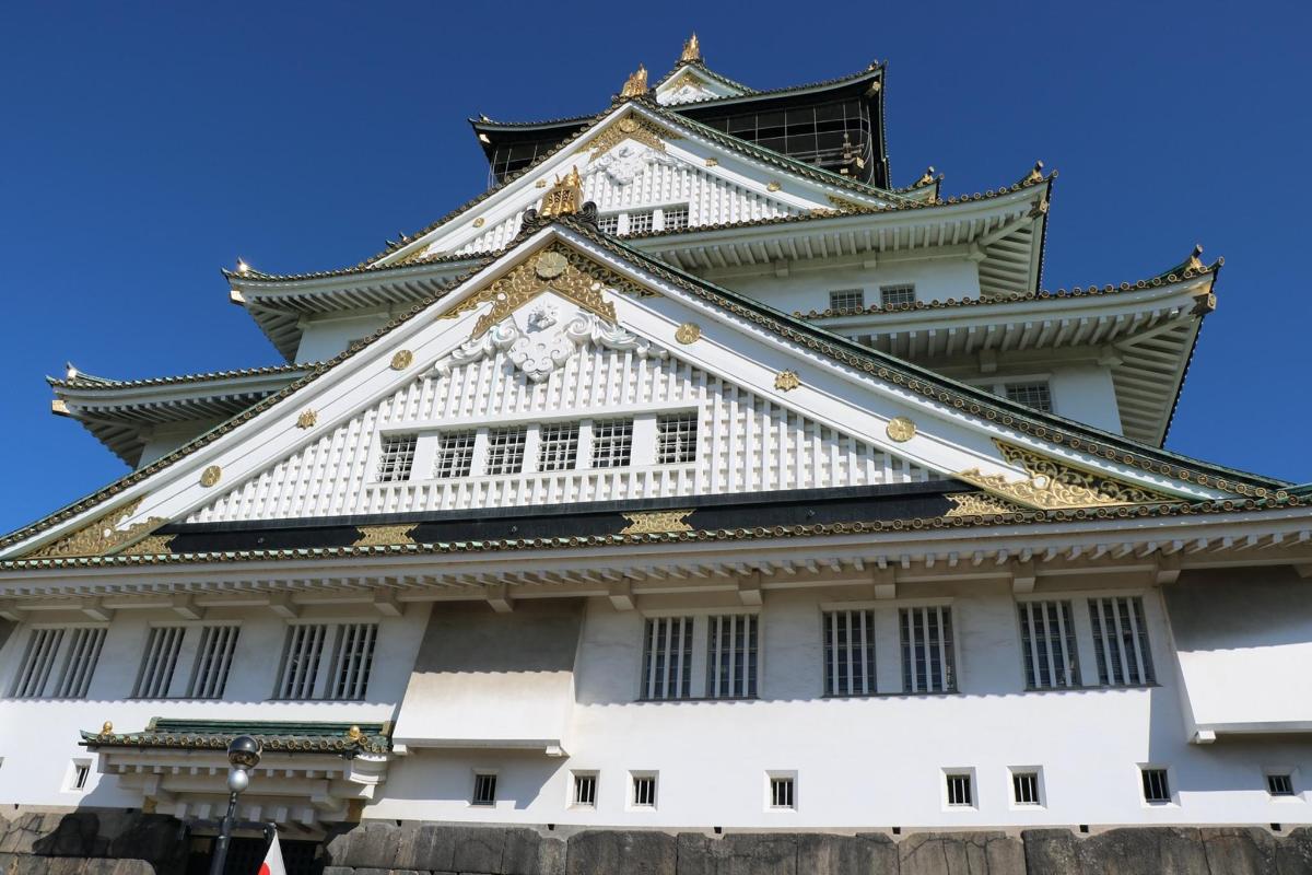 a tall white building with a black roof
