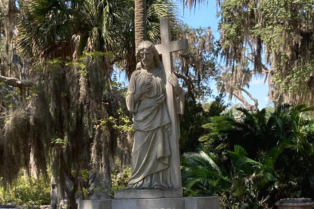a statue of a man holding a cross