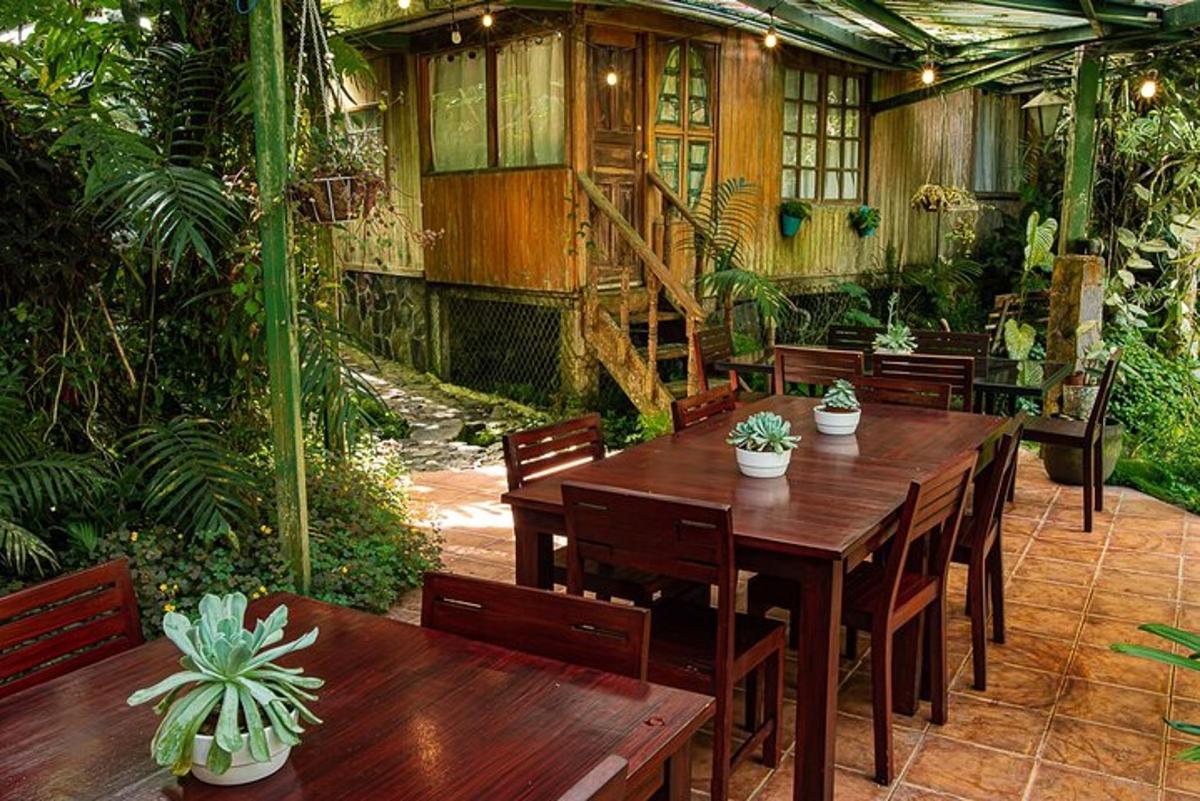 a patio with a wooden table and chairs