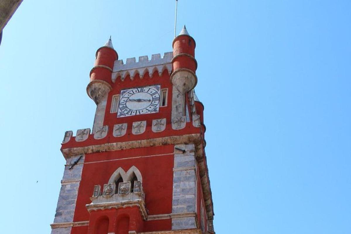 a tall red clock tower with a clock on it