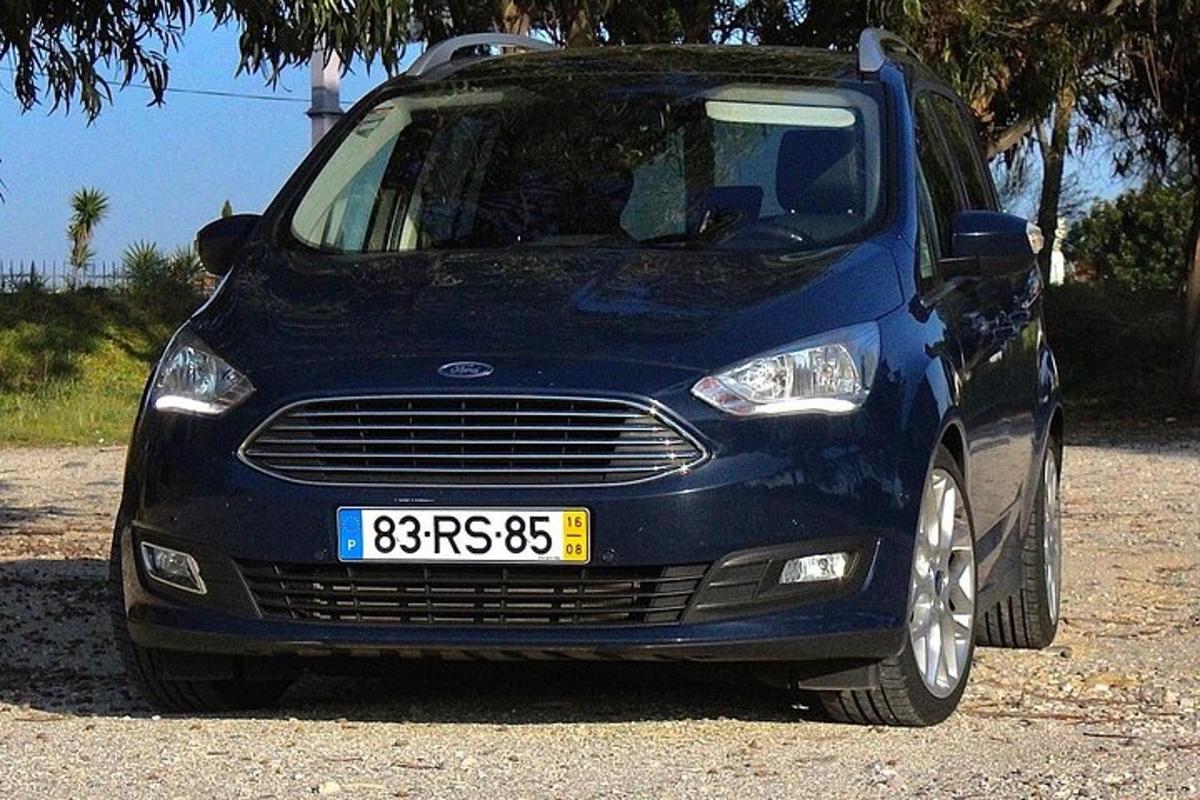 a blue car parked in a gravel lot