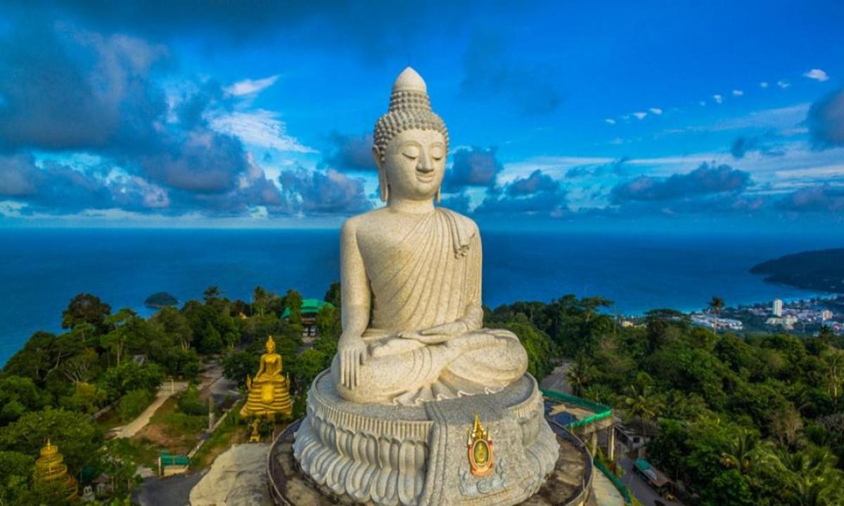 a large statue sitting on top of a mountain