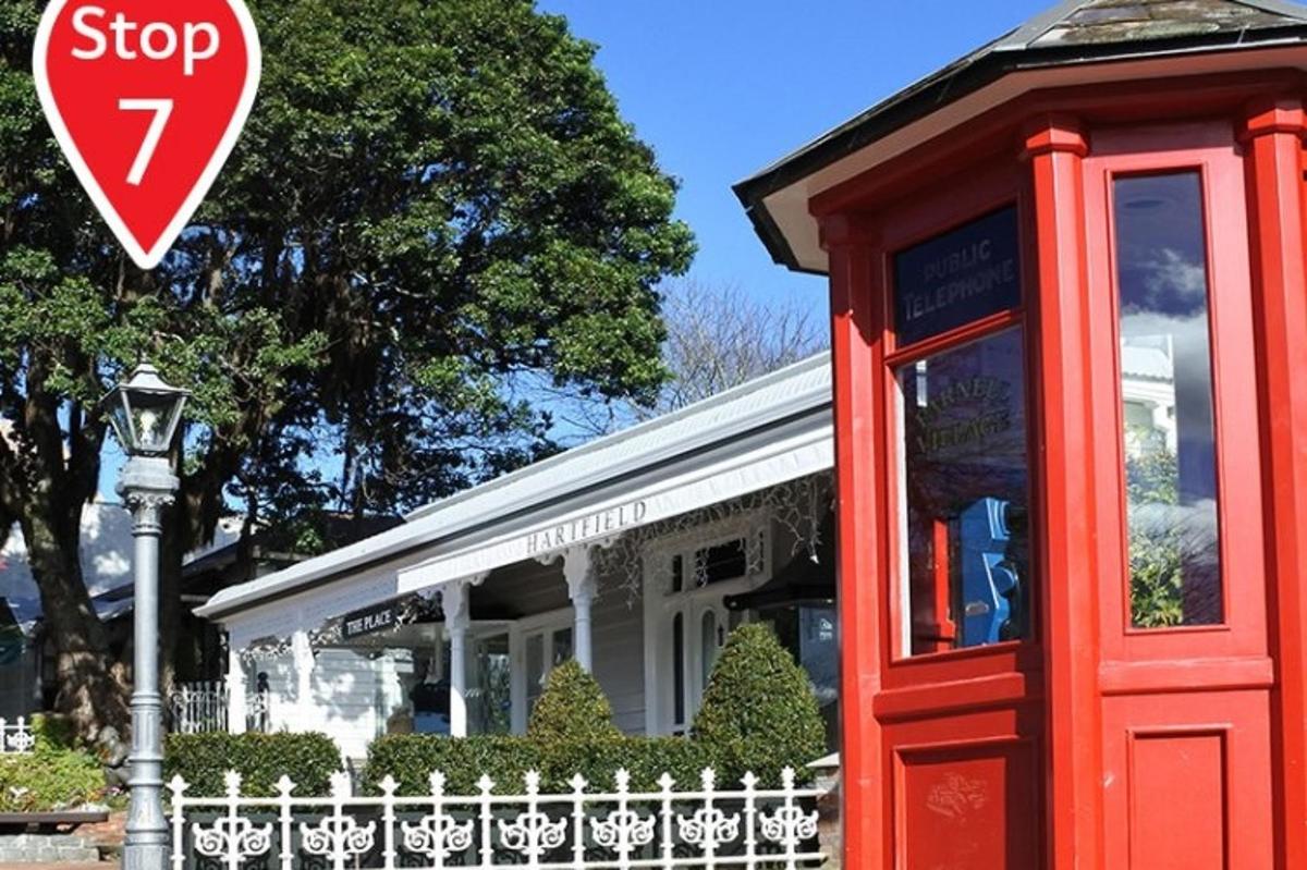 a stop sign in front of a phone booth